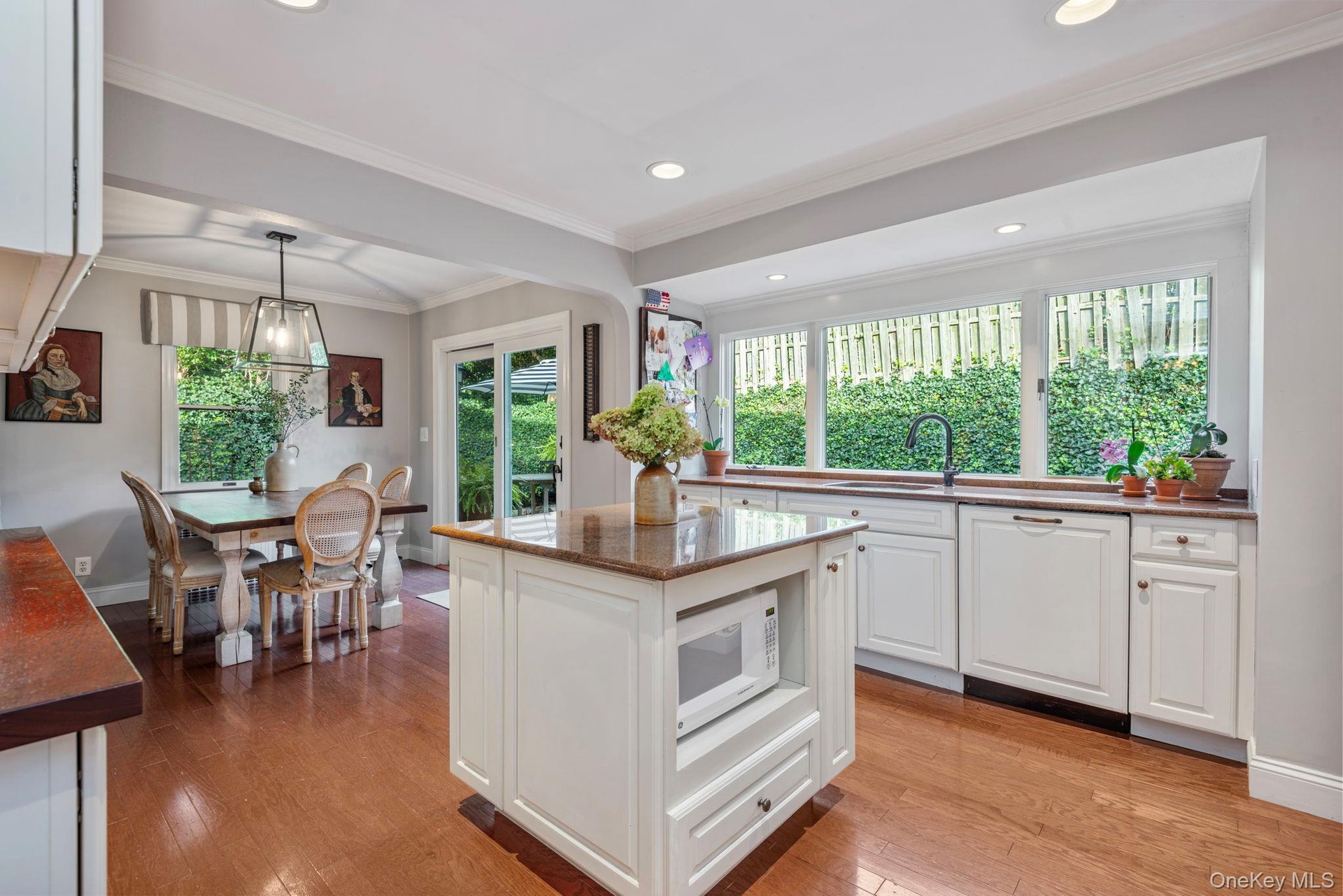 Bright and sunny classic kitchen with large windows looking out to the gardens.