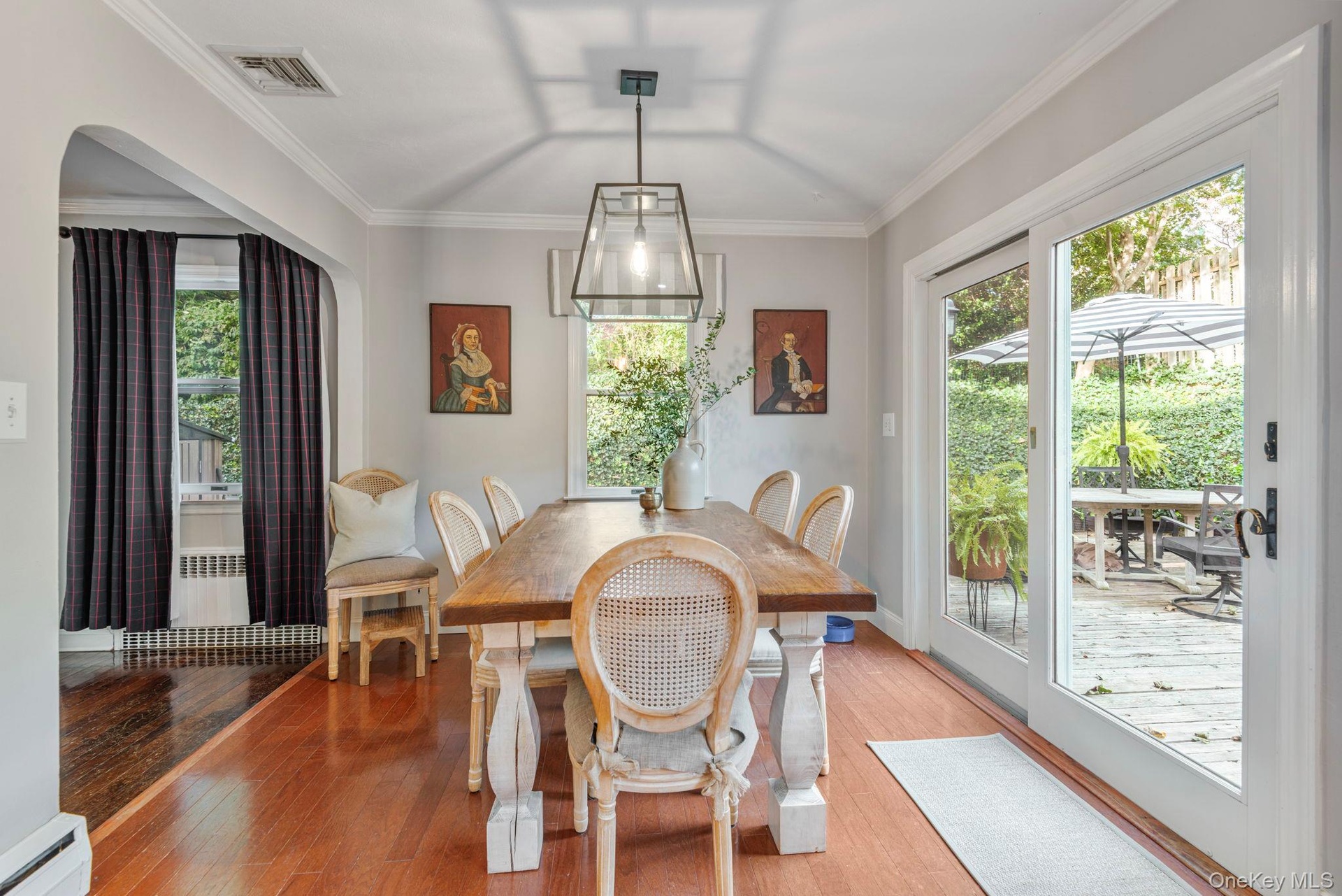 Sunny dining room with sliders out to the gardens.