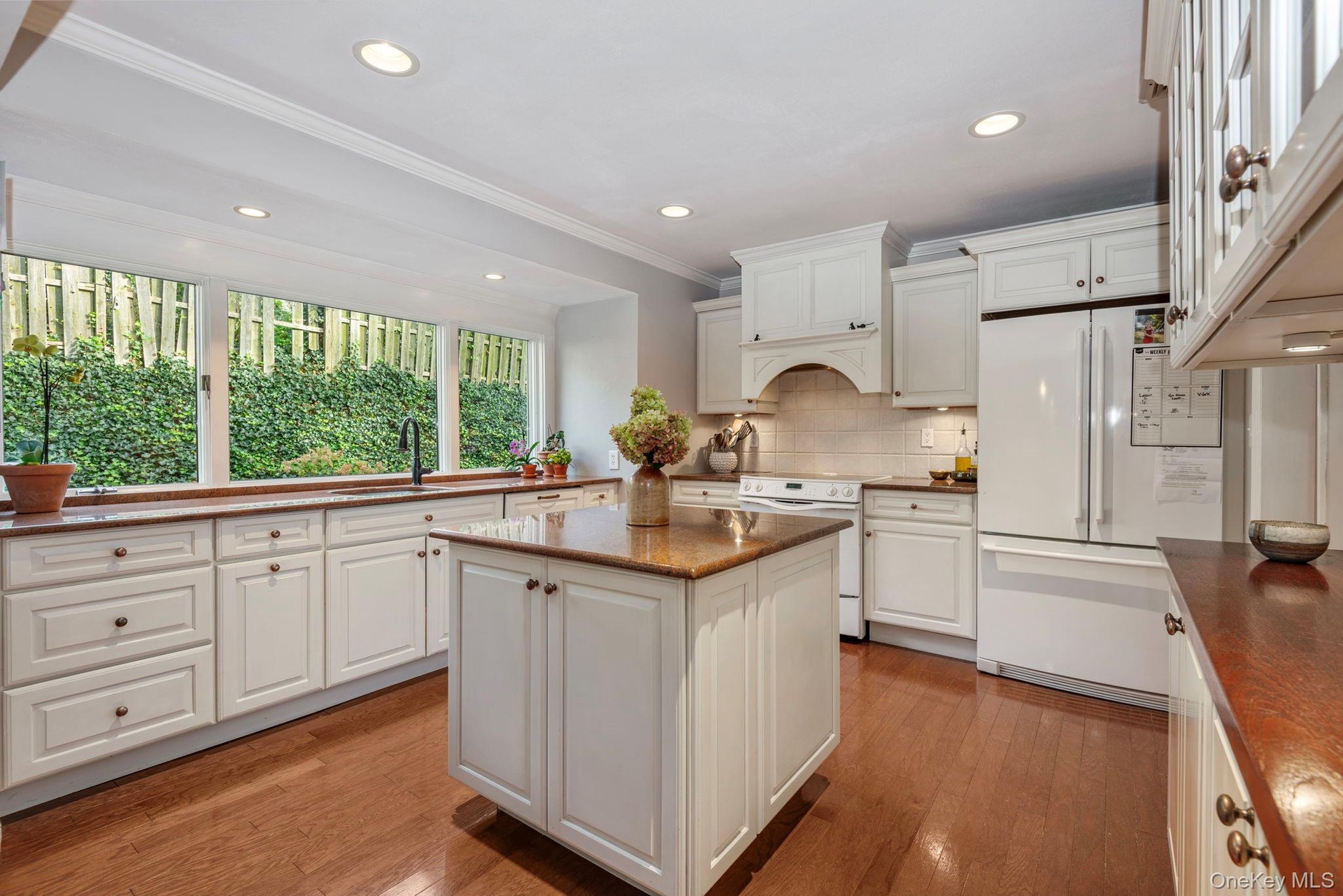 Beautiful kitchen with island and newer refrigerator.