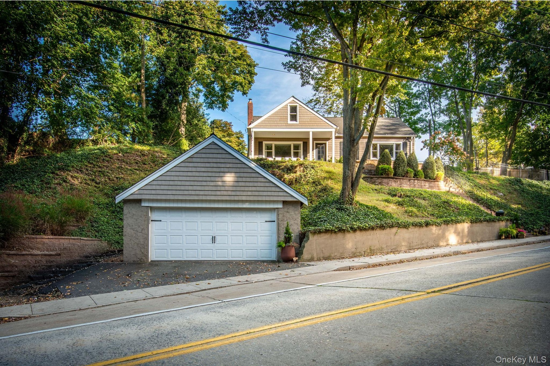 House high up on a hill with great views. Large garage on street level.