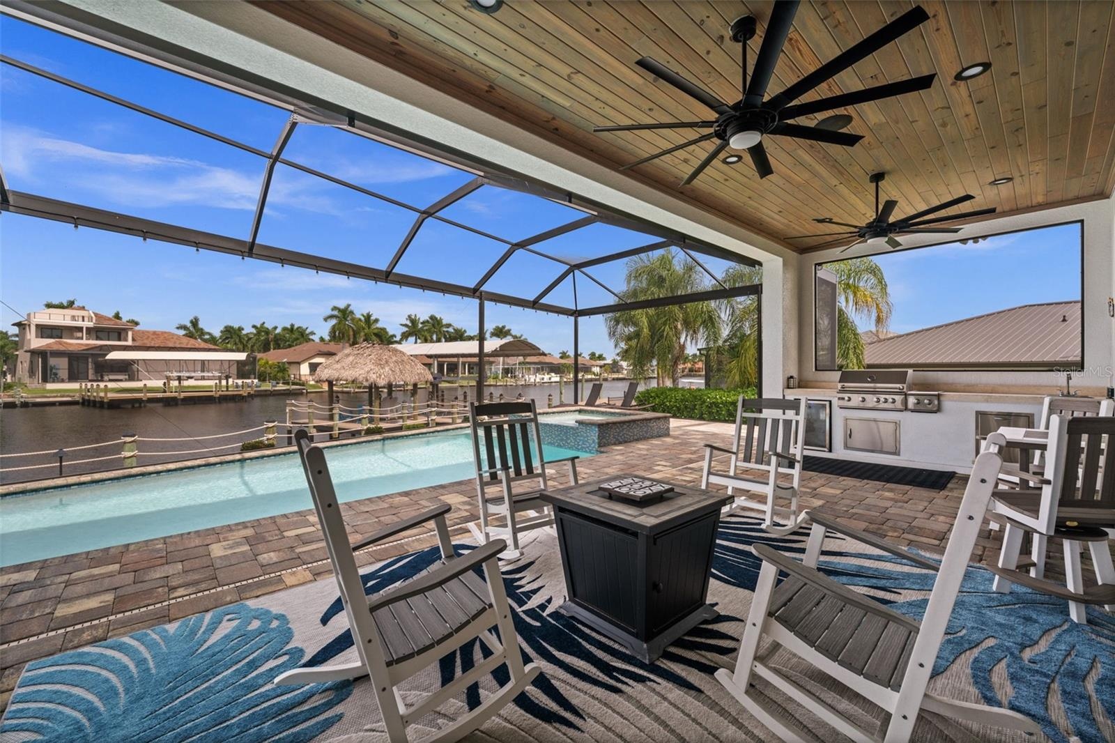 Beautiful details throughout this build. From the wood ceilings in the lanai, to the picture window screen cage with amazing views