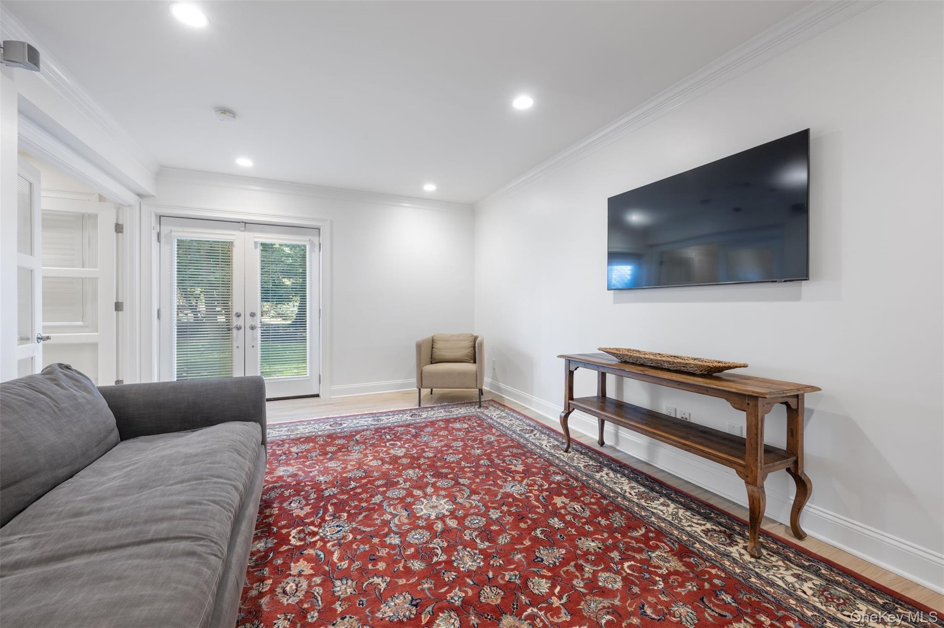 Lower level bedroom/tv room with doors to the yard.