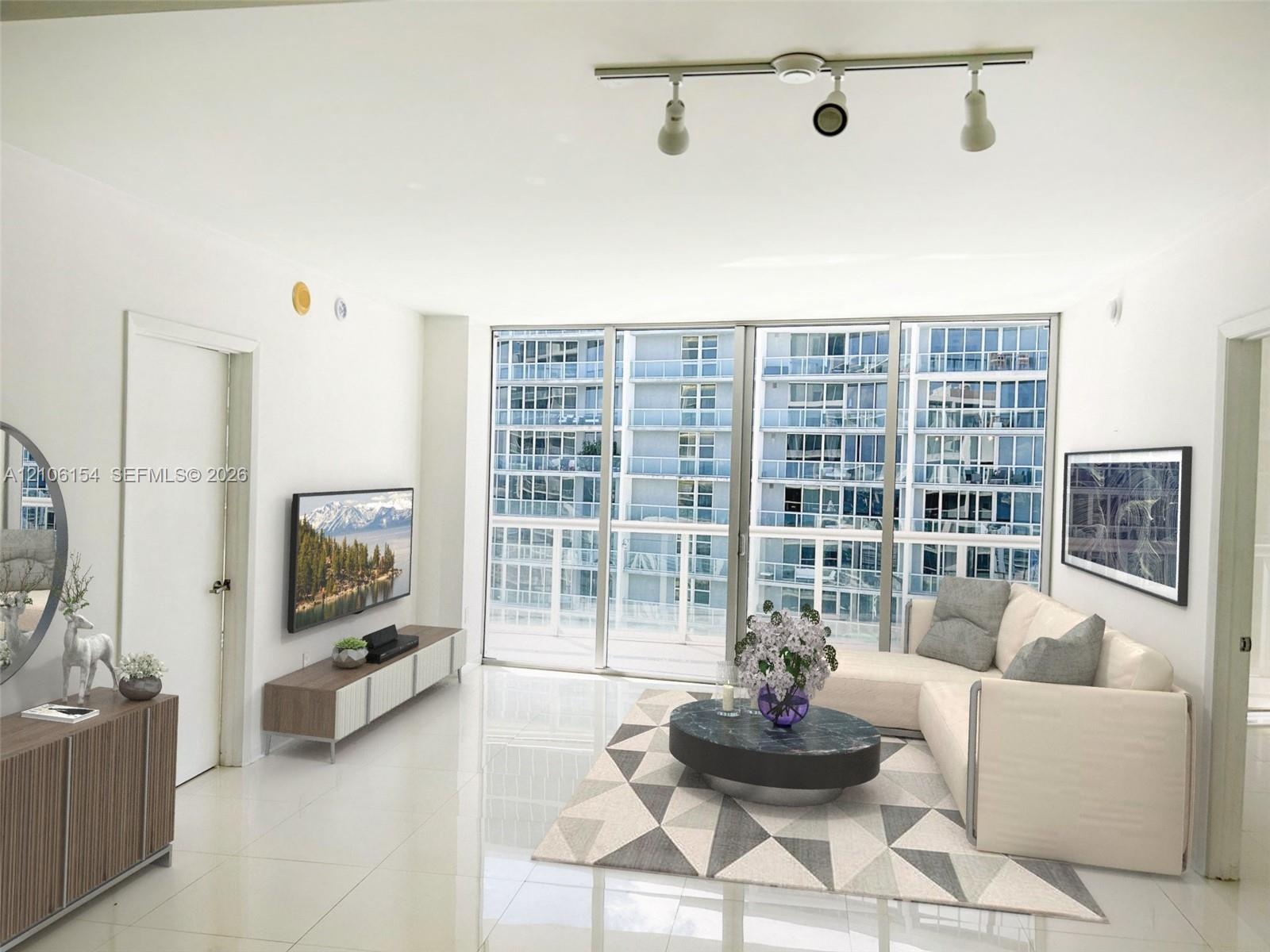 Floor-to-ceiling glass panel windows, polished tile flooring, and adjustable track lighting