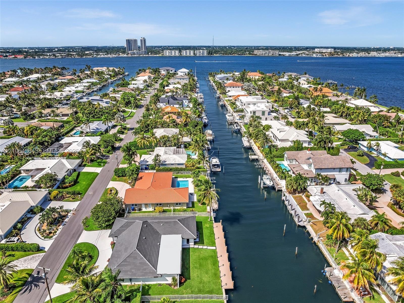 Waterfront canal location featuring direct deep-water access, fixed dock infrastructure, and a landscaped backyard
