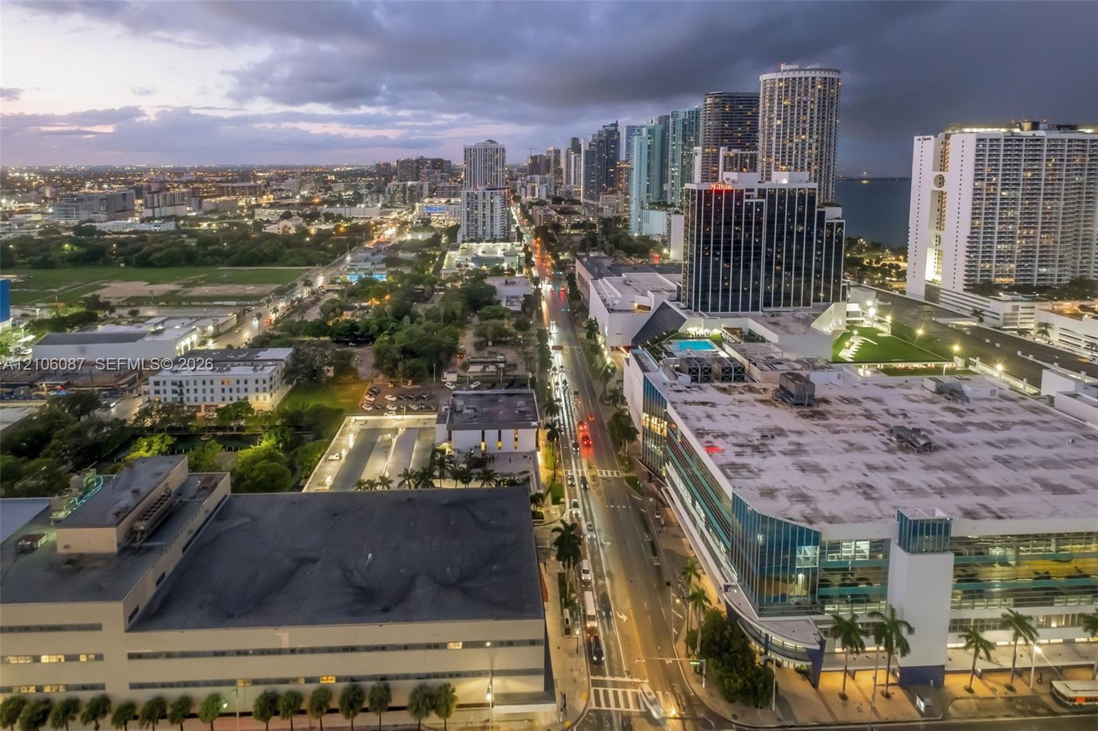 Aerial perspective of an urban setting featuring high-rise architecture, concentrated commercial developments, metropolitan thoroughfares, and proximi