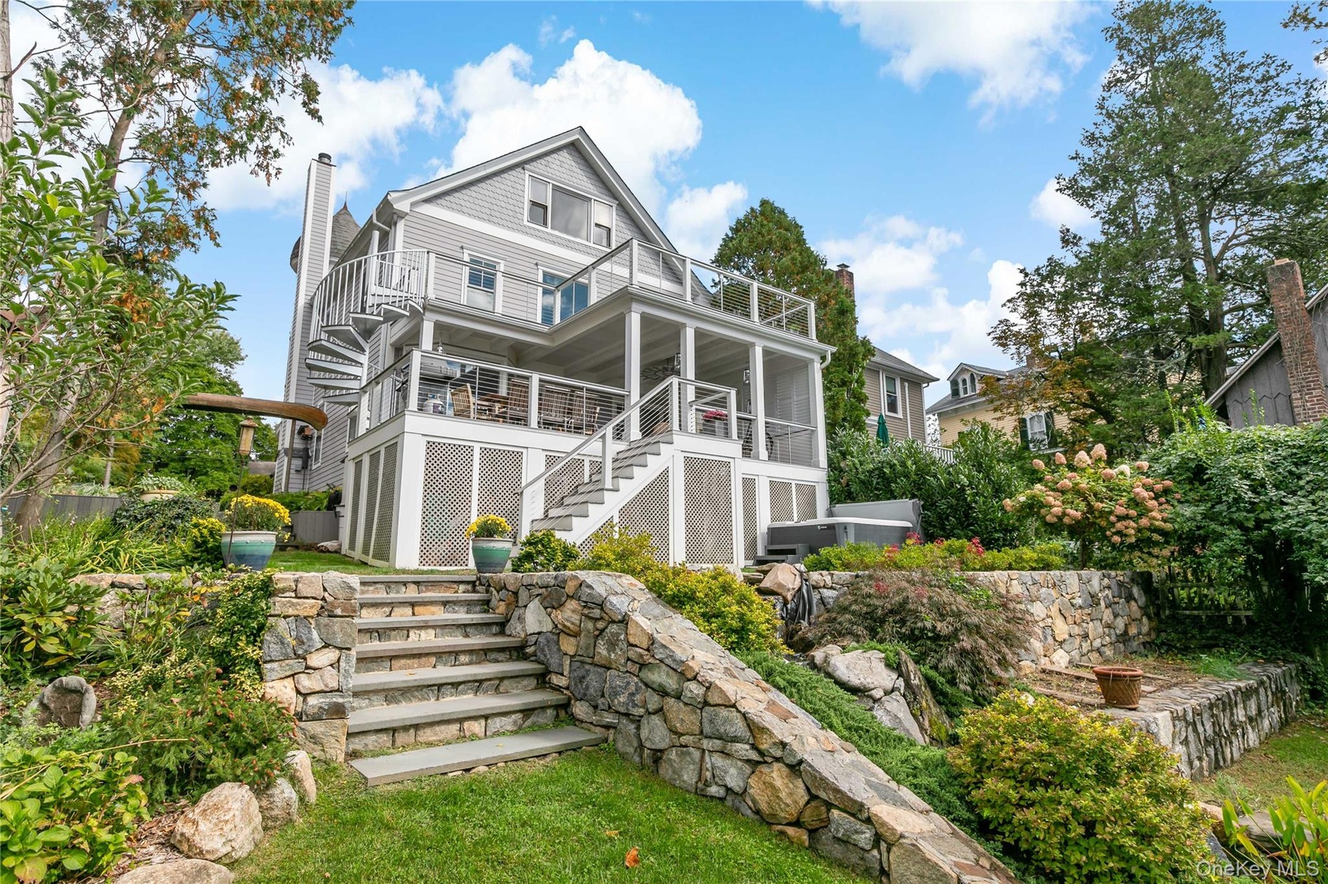 Luxury living with koi pond, hot tub and two tier decking. Please note whimsical canoe archway entrance.