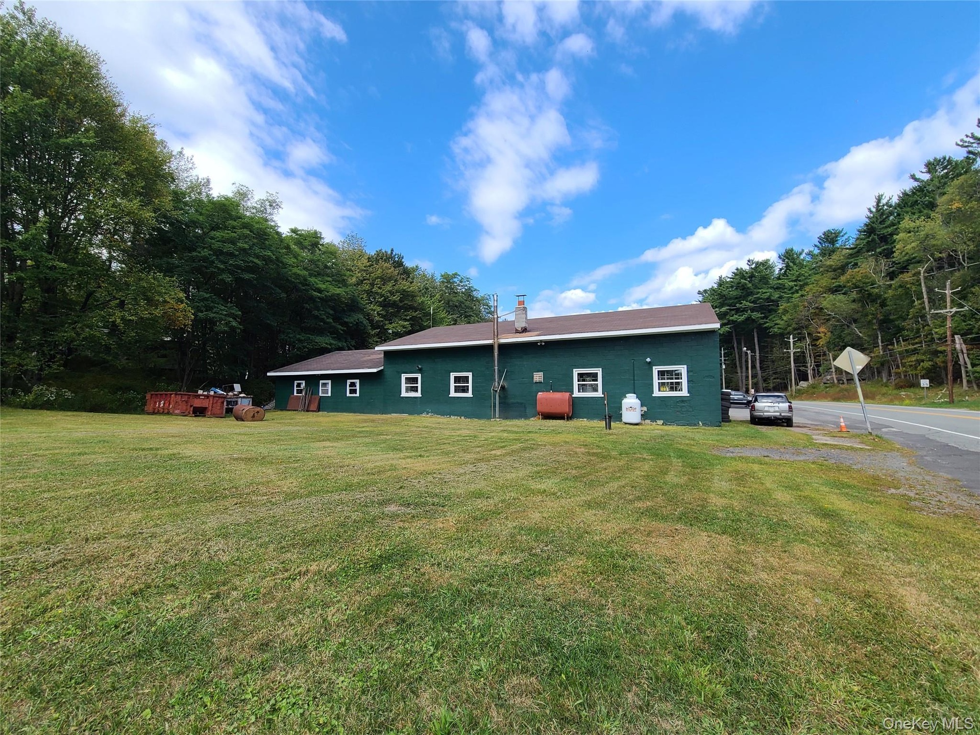 Back of property featuring a lawn and heating fuel