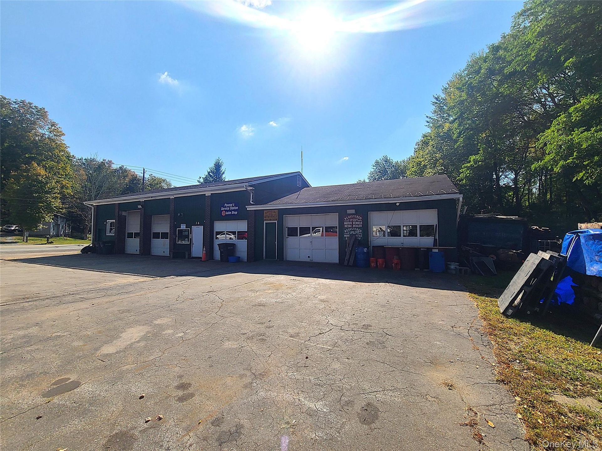 Garage featuring asphalt driveway