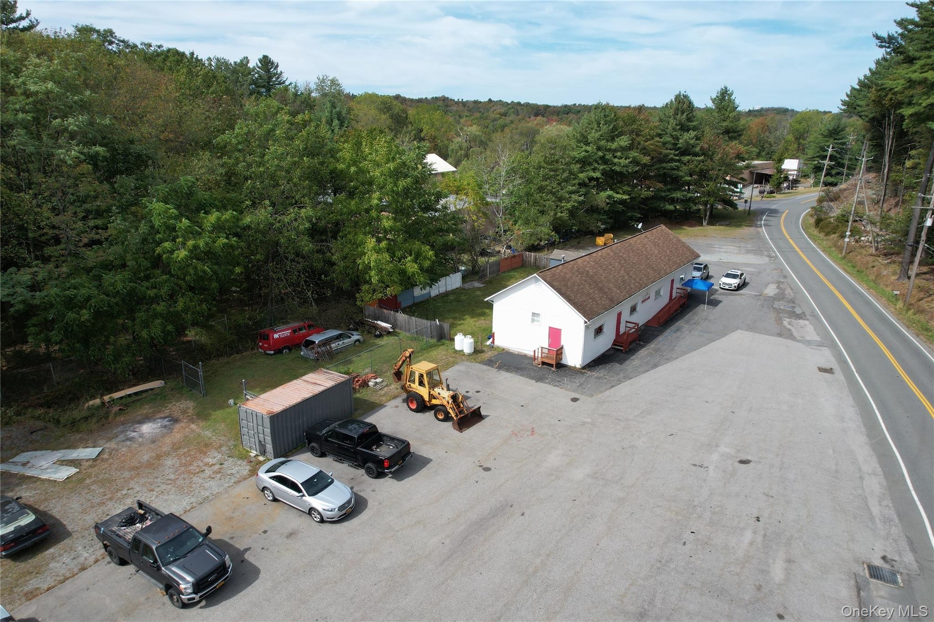 View of subject property with a forest