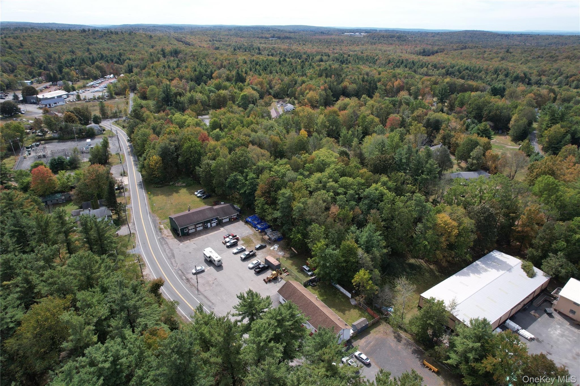 View of property location featuring a forest