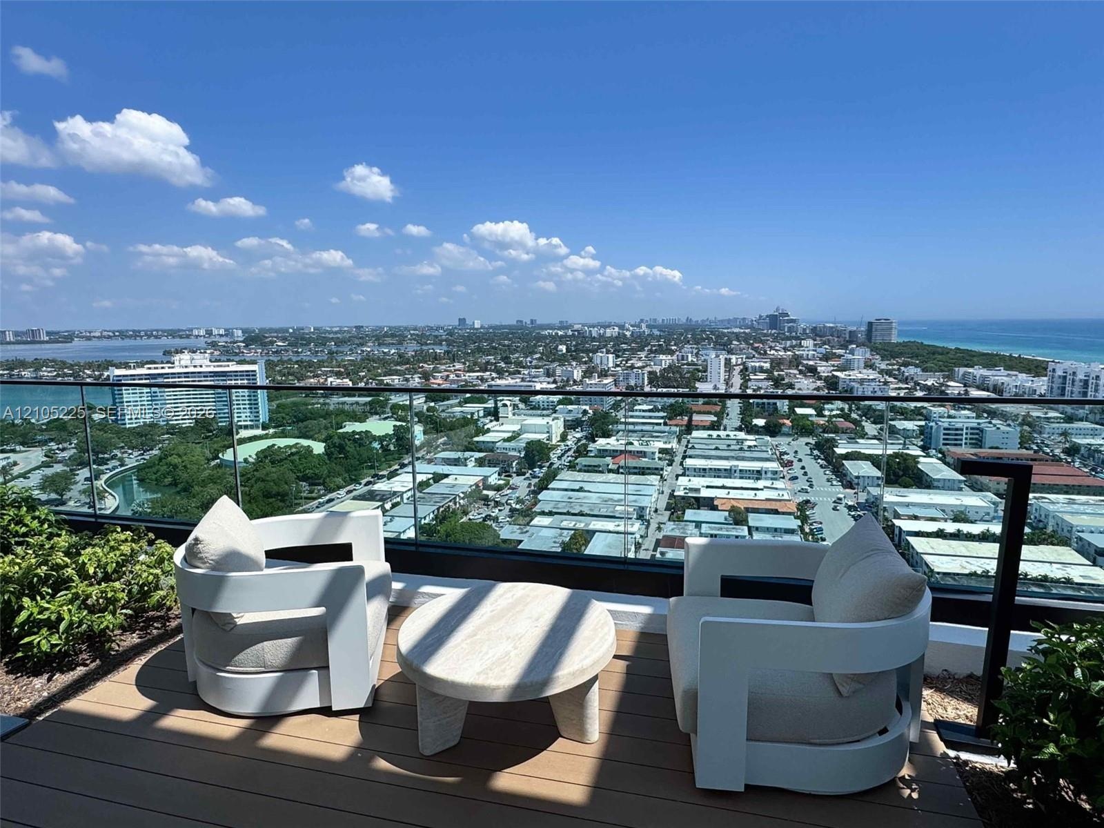 Expansive outdoor terrace featuring wood-finish decking, a glass railing, and integrated planters