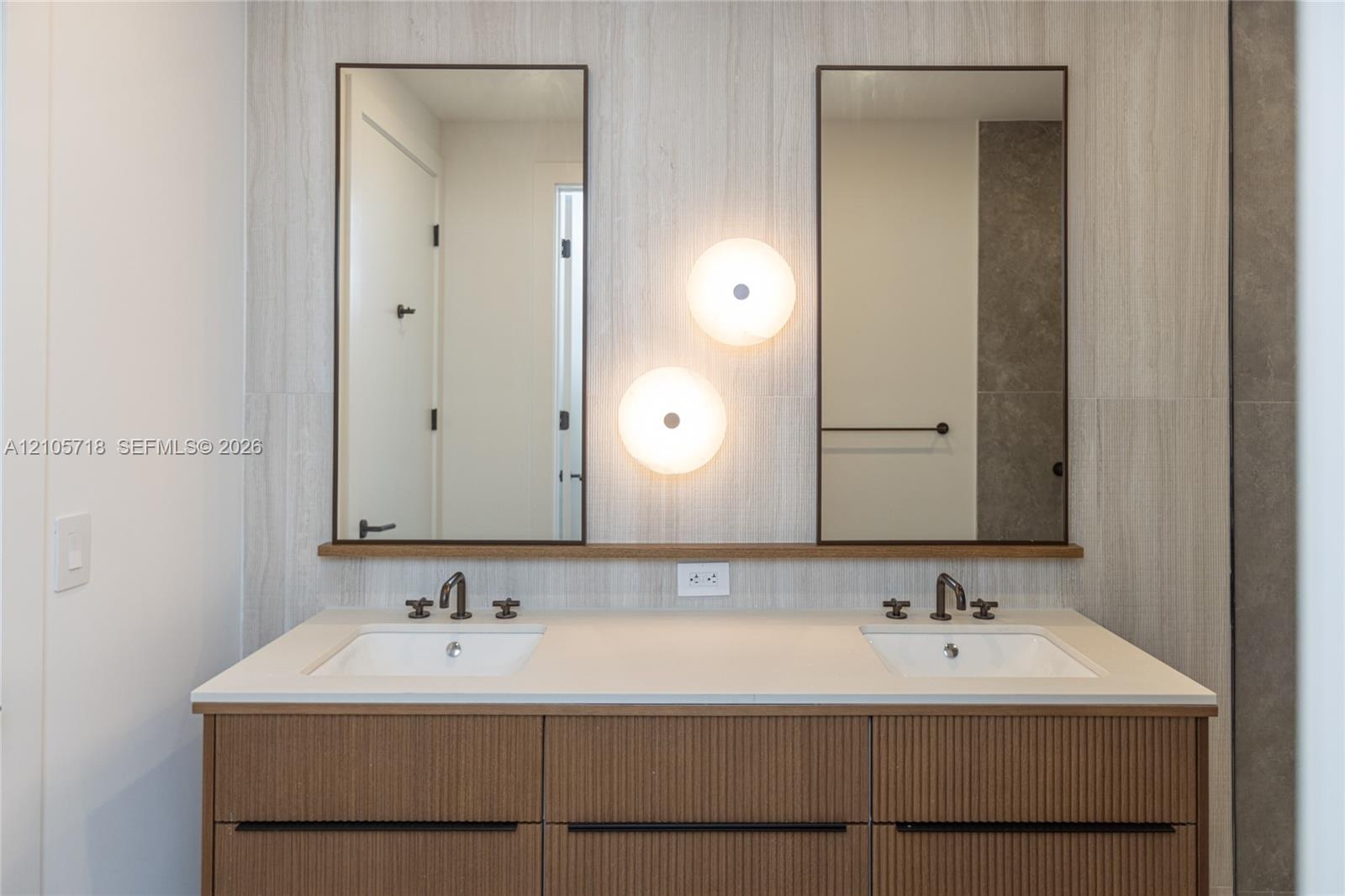Master bath Double vanity with a textured wood-finish cabinet, stone-finish countertop, dual rectangular undermount sinks, bronze-finish widespread fa