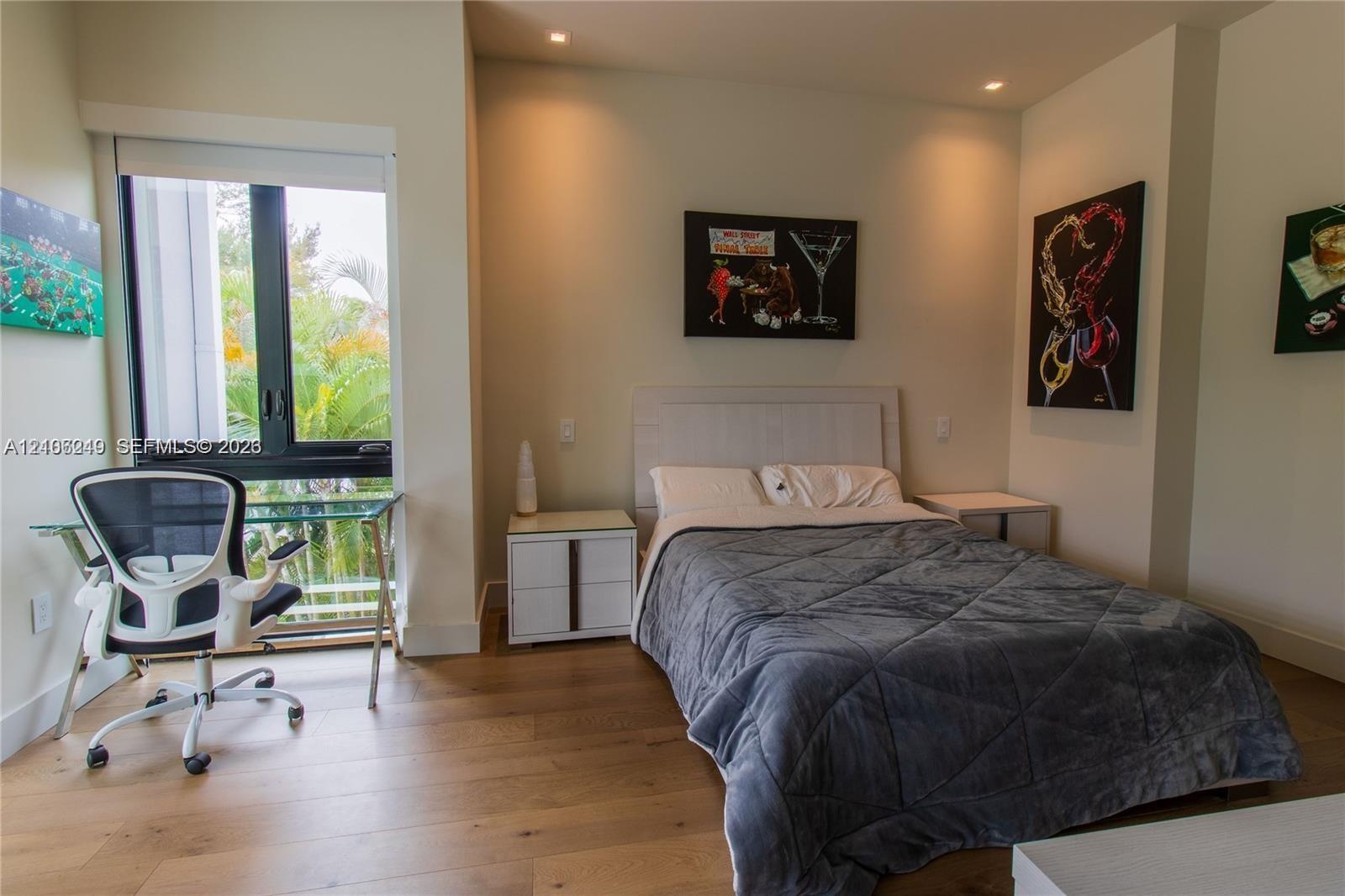 Wood-finish flooring, recessed lighting, and large floor-to-ceiling windows with black frames
